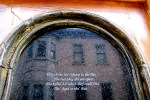 arch at top of window in a tombstone door at 109 S. Ferry St. in the Schenectady NY Stockade with the second half of the Walter Wilie Massacre Ballad –&nbsp;08Aug2011