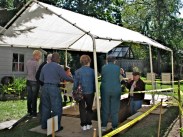 Walkabout 2009 - Community Archaeology Project to find original Stockade wall explained to Walkabout group (trench behind 32 Front St.)