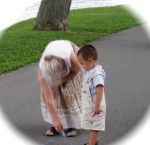 Hainua watches while a hopscotch court is drawn in chalk at Riverside Park at his sister’s 1st birthday party –&nbsp;28July2010