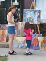 a young fan studies Gwendolyn Lett's art in front of the former site of Arthur's Market - - 60th Annual Stockade Villagers' Outdoor Art Show - 10Sep2011