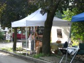 an exhibit goes up on a sunny Saturday morning on Green St - 60th Annual Stockade Villagers' Outdoor Art Show - 10Sep2011