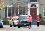 two runners outpace the rear escort cars on Front St. – Schenectady NY Stockade – Stockade-athon 2012 –&nbsp;11Nov2012